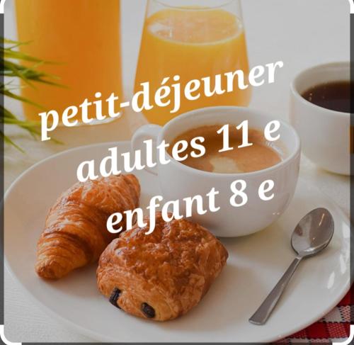 a plate with two croissants and a cup of coffee at le chalet de la ferme du tertre in Villers-au-Tertre