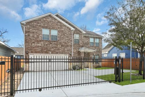 a brick house with a black fence at *Heart of Houston* Pet friendly/14ppl/4br/2.5b in Houston