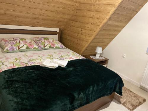 a bedroom with a bed with two shoes on it at Apartamenty Natalii in Nowy Targ