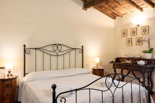 a bedroom with a bed and a table with lamps at Borgo dei Fondi in Siena