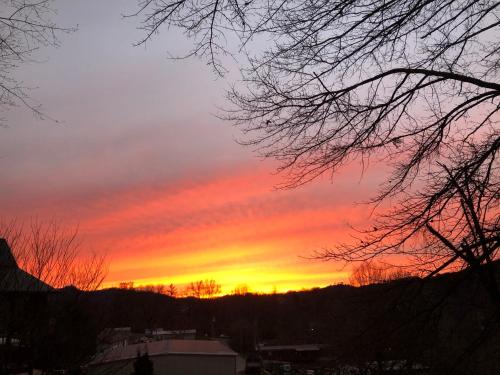 a sunset with the sun setting in the sky at Twin Oaks in Bryson City