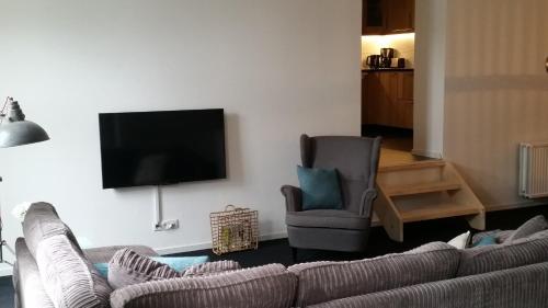 a living room filled with furniture and a tv at Oekepoek Down Town in Enschede