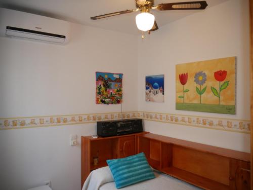 a bedroom with a bed and paintings on the wall at Precioso apartamento en Cabo de Gata in El Cabo de Gata