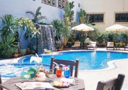 a swimming pool with a table and a table sidx sidx sidx at LK Pavilion Executive Serviced Apartment in Pattaya Central