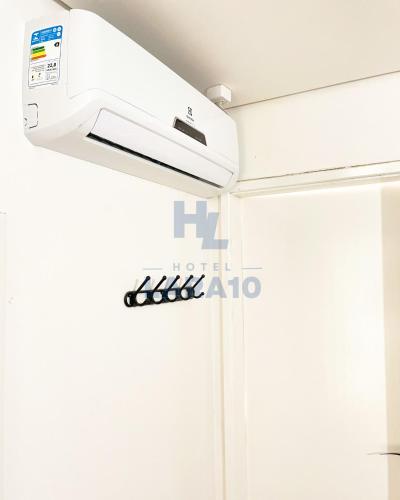 a white air conditioner in a room at Hotel Lara 10 Curitiba in Curitiba