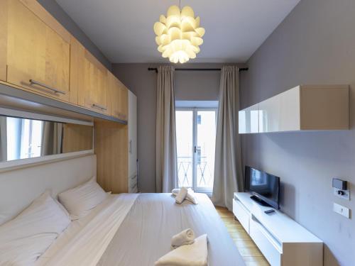 a bedroom with a large bed and a chandelier at Spanish Steps, Suite Dominic, Strollingrome in Rome