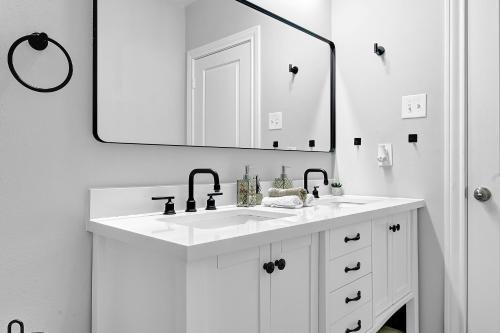 a white bathroom with a sink and a mirror at Sweet Houston, 14 People, 4 Bethroom, 2 Full Restrooms in Houston