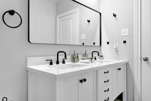 a white bathroom with a sink and a mirror at *Sweet Houston*/12ppl/3br/1b in Houston