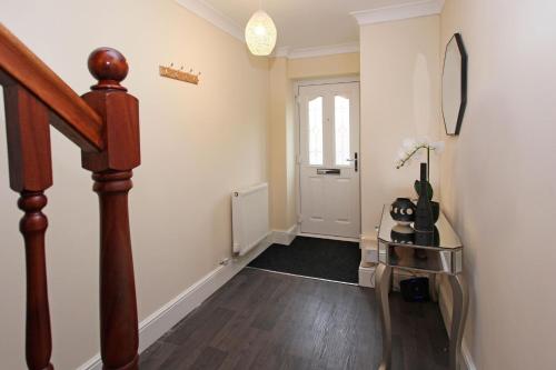 a hallway with a stairway with a door and a stair at St Julians Place in Shrewsbury