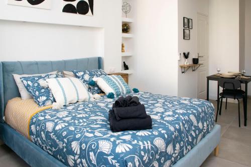 1 dormitorio con cama azul y edredón azul y blanco en Au Pied du Vieux-Port Wifi Netflix, en Marsella