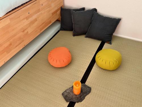 a bed with two ottomans and two pillows at Studio Serenity, 4 min walk to center! in Crans-Montana