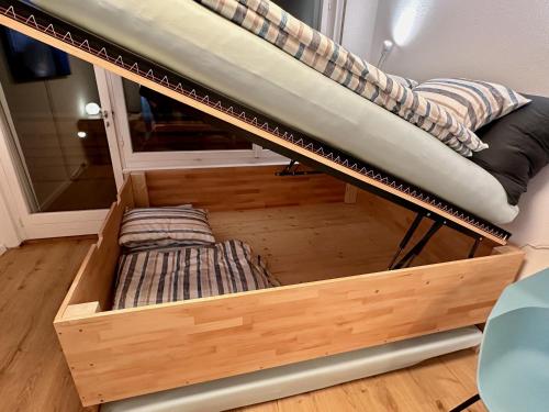 a bunk bed with two pillows on top of it at Studio Serenity, 4 min walk to center! in Crans-Montana
