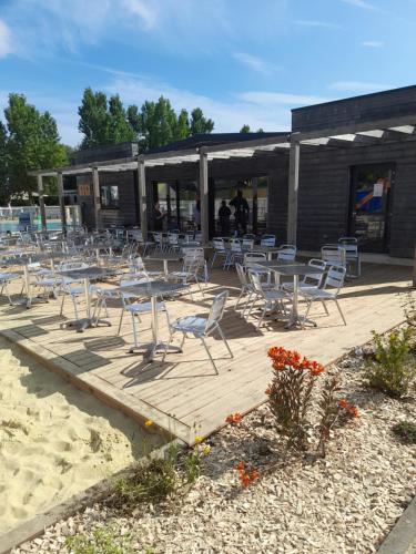 a group of tables and chairs on the beach at RIVA BELLA MH 171 in Ouistreham