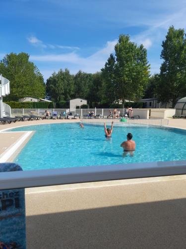 a group of people swimming in a swimming pool at RIVA BELLA MH 171 in Ouistreham