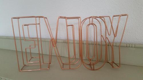 a group of metal hangers hanging from a wall at Oekepoek Down Town in Enschede