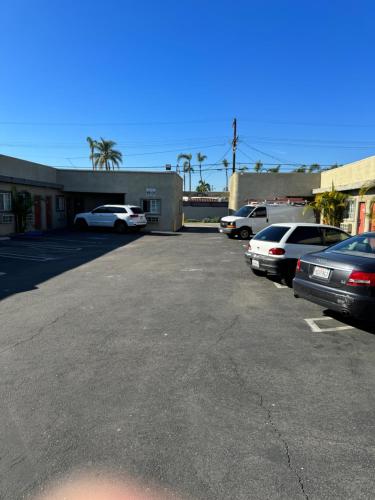 a parking lot with several cars parked in it at La Cienega Inn Motel in Los Angeles