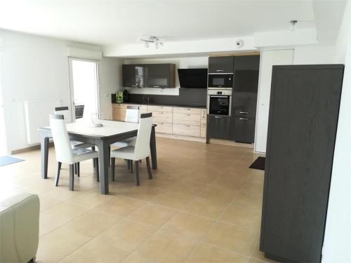 une cuisine et une salle à manger avec une table et des chaises dans l'établissement Résidence Coteau - Charmant appartement de 70m² dans une résidence à deux pas de la plage. MAE-6584, à Pléneuf-Val-André