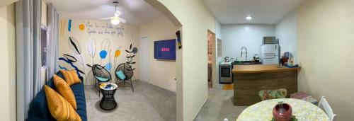 two pictures of a kitchen and a living room at Casinha da Nete (6 pessoas) in São Sebastião