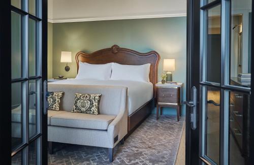 a hotel room with a bed and a chair and a window at Pendry Natirar in Peapack