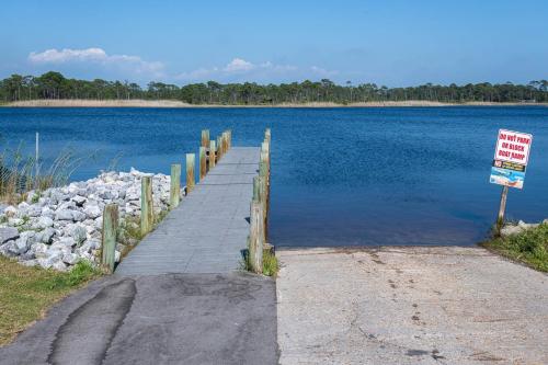 a boardwalk leading into a large body of water at Artless Sprite in Santa Rosa Beach