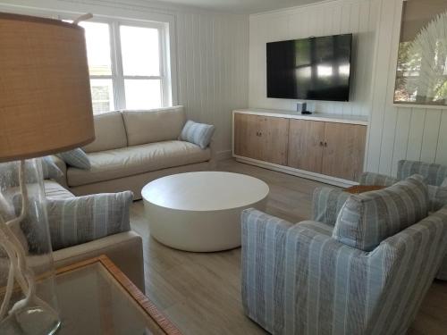 a living room with a couch and a table at Artless Sprite in Santa Rosa Beach