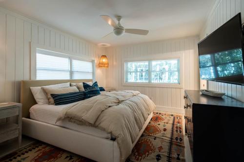 a bedroom with a bed and a television in it at Artless Sprite in Santa Rosa Beach