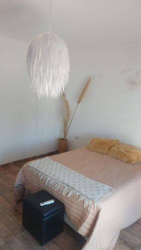 a bedroom with a bed with a lamp and a plant at La Casa de Sole in Paraná