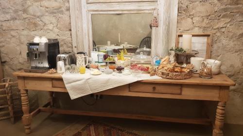 a table with food and drinks on it with a mirror at Le Lodge des Flâneurs in Vielsalm