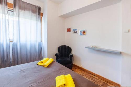 a room with a bed with yellow objects on it at Porto Centrum Apartments in Porto