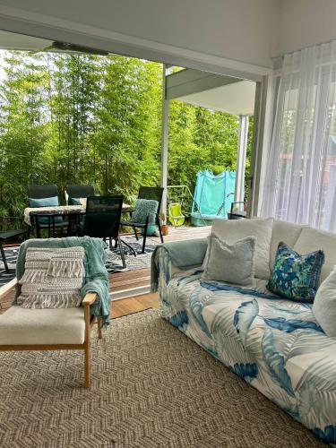 a living room with a couch and a patio at Woonona Family Beach Villa 5 min walk to beach in Woonona