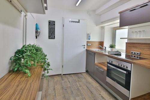 a kitchen with a white refrigerator and a sink at Ferienwohnung 2 - b48936 in Lechbruck