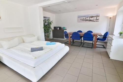 1 dormitorio con 1 cama, mesa y sillas en Ferienwohnung 2 - b48936 en Lechbruck