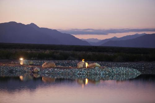 a person sitting on the shore of a body of water at Rosell Boher Winery Lodge & Spa in Agrelo