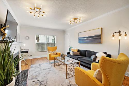 a living room with a couch and chairs at The Bishop's Haven in Houston