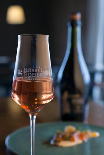 a glass of wine next to a plate of food at Rosell Boher Winery Lodge & Spa in Agrelo