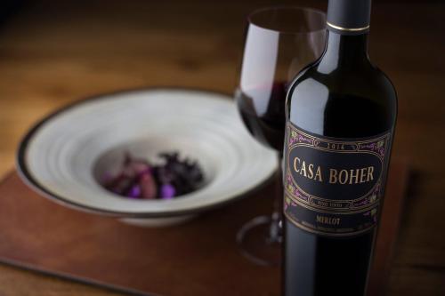 a bottle of wine next to a bowl of food at Rosell Boher Winery Lodge & Spa in Agrelo