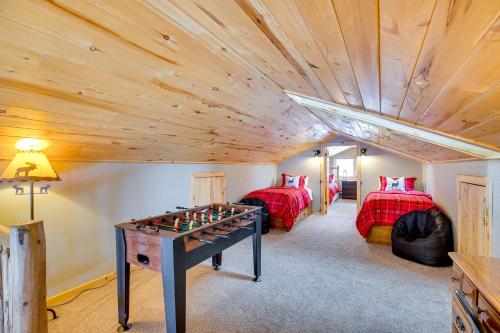 a room with a foosball table and two beds at Spacious Gunnison Home Ski, Hike, Bike and Fish! in Gunnison