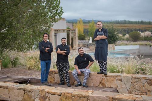 a group of men standing on a stone wall at Rosell Boher Winery Lodge & Spa in Agrelo