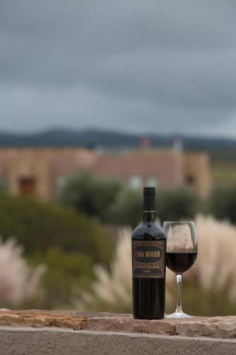 a bottle of wine next to a glass of wine at Rosell Boher Winery Lodge & Spa in Agrelo