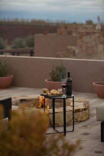a table with a glass of wine and food on a patio at Rosell Boher Winery Lodge & Spa in Agrelo