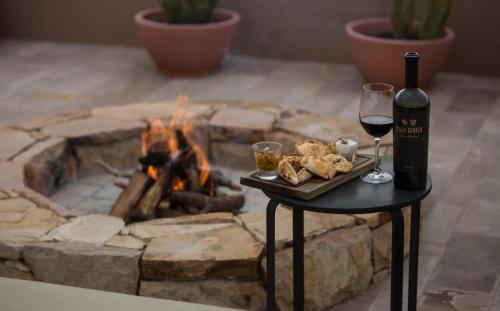 a glass of wine and a tray of food and a fire place at Rosell Boher Winery Lodge & Spa in Agrelo