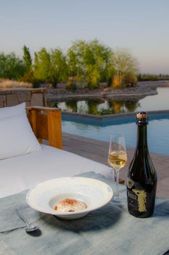 a bottle of wine and a plate of food and a glass at Rosell Boher Winery Lodge & Spa in Agrelo