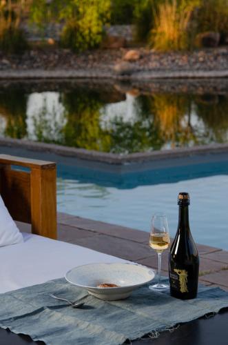 a bottle of wine sitting on a table with a glass at Rosell Boher Winery Lodge & Spa in Agrelo