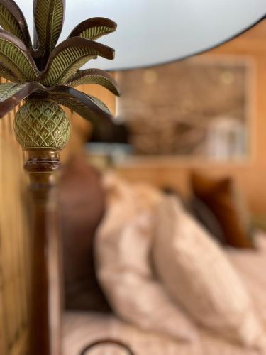 a pineapple on a wooden pole in a living room at The Bay Cottage - Located Directly Across the Road from 2 Swimming Beaches in Great Barrier Island