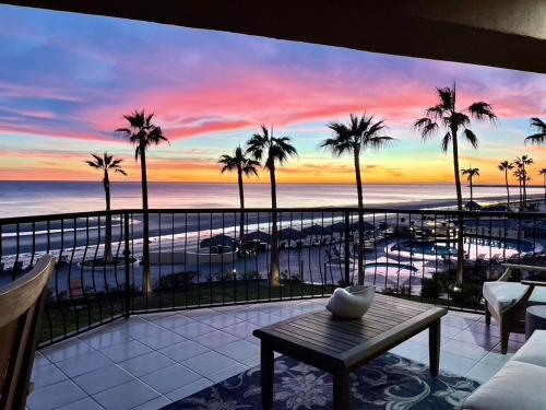 a room with a view of the ocean and palm trees at Sonoran Sea Resort BEACHFRONT Condo E203 in Puerto Peñasco