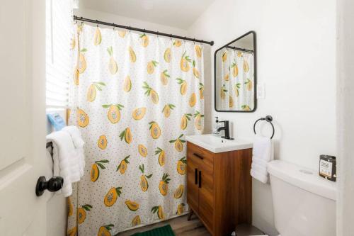 a bathroom with a shower curtain and a sink at Hidden Gem 1 Bdrm Top Floor Condo in San Diego