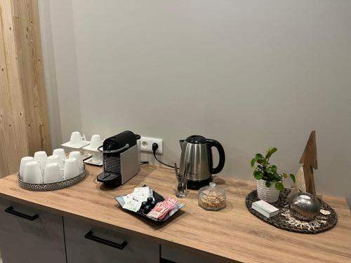 a counter with a coffee maker on top of it at Maison d hôtes SPA Pivoine et Colibri in Domfessel