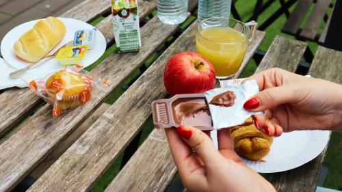 a picnic table with a plate of food and an apple at Mystay Porto Batalha in Porto