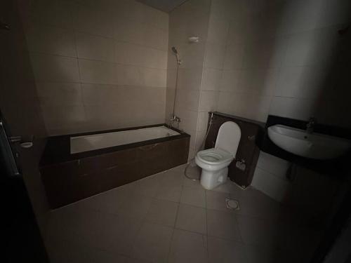 a bathroom with a toilet and a sink at Diomond view 4 in Dubai