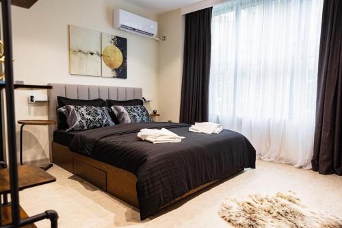 a bedroom with a bed with two towels on it at LUXIMO ROOM in Veliko Tŭrnovo
